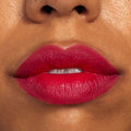 Lips wearing ColourPop Lippie Pencil in I Heart This, lining and filling the mouth with a vibrant fuchsia-red hue for a smooth satin-matte finish; extreme close-up beauty shot showcasing clean edges and rich, long-wearing pigment.