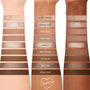 Deja Brew ColourPop Shadow Palette swatches run across three forearms, showcasing ten neutral matte and shimmer eyeshadows - Salted Caramel to Double Shot - labeled and ranging from creamy beige to espresso brown for everyday eye looks.