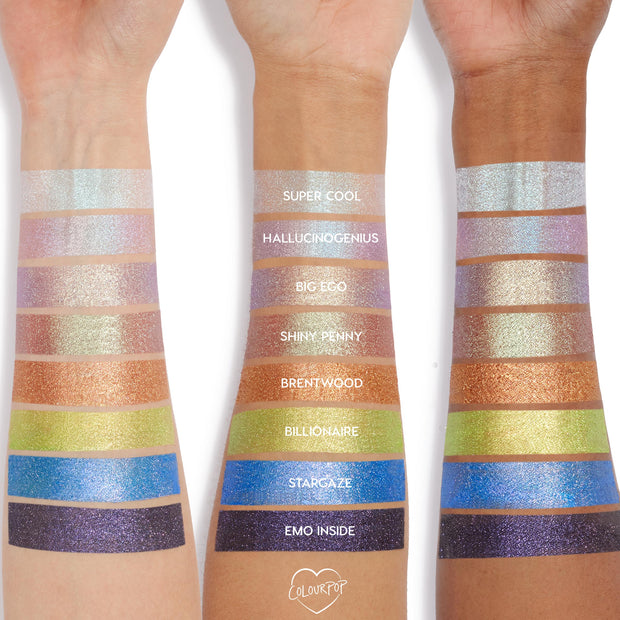 Three arms in varying skin tones display swatches of Colourpop Mystical Jelly Much Shadow, showing shimmery eyeshadow shades Super Cool, Hallucinogenius, Big Ego, Shiny Penny, Brentwood, Billionaire, Stargaze, and Emo Inside in a vertical rainbow layout.