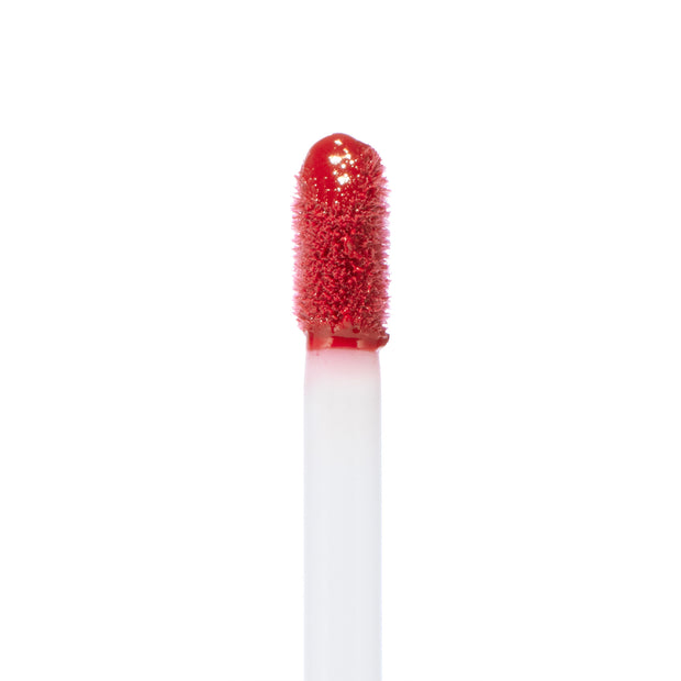 Doe-foot applicator coated in rich rosy-red lip color, displaying the Keep It Classy Ultra Blotted Lip shade from the ColourPop Ultra Blotted Lip line, upright against a clean white background to highlight texture and pigment.
