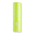 ColourPop Lip Balm tube in Key Lime standing upright with cap on, showcasing a bright lime‑green case with white lime illustrations and “KEY LIME LIP BALM” text, photographed isolated against a clean white background.