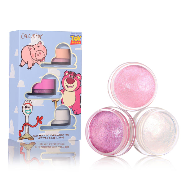 Play All Day ColourPop Jelly Much Shadow trio showing three open gel eyeshadows - shimmery light pink, vibrant fuchsia-lilac, and iridescent pearl - set beside a Toy Story-themed box with Hamm, Lotso, and Forky on a white studio background.
