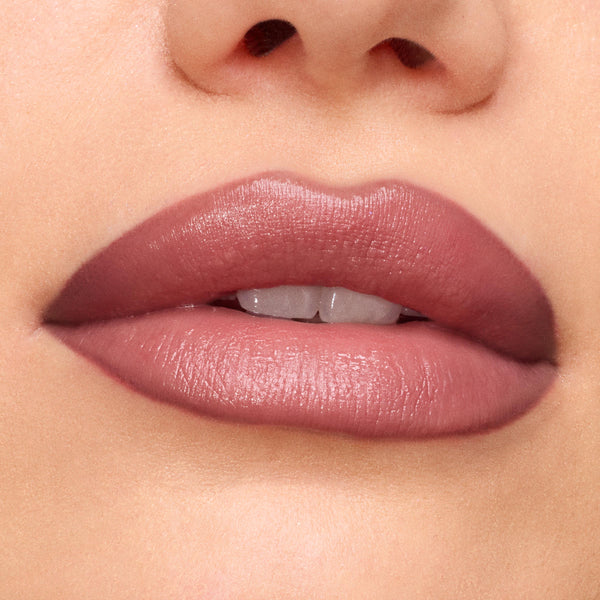 Close-up lips wearing Anti-Hero Lux Lipstick in a mauve-rose satin finish, showing even, full-coverage payoff and creamy texture; studio beauty swatch for ColourPop Lux Lipstick.
