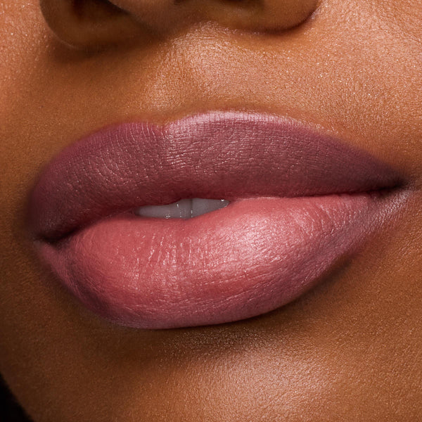 Full lips wearing Anti-Hero Lux Lipstick in a creamy mauve-rose, showing a smooth satin finish in a tight macro beauty shot; ColourPop Lux Lipstick color payoff and texture highlighted under studio lighting.