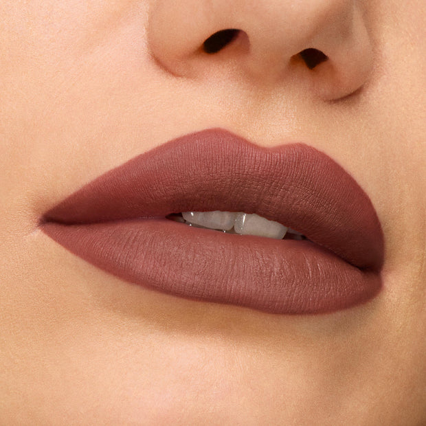 Matte mauve-brown lips wearing Bella! Where the Hell Have You Been, Loca? ColourPop Power Pout Lipstick, shown in a tight beauty close-up, highlighting smooth full coverage, crisp edges, and a soft-focus finish against natural skin.