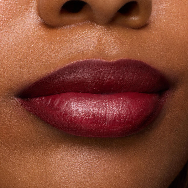 Lips wear Secret Kiss, a deep berry-wine shade, precisely lined and filled for a satin finish, showcasing rich payoff and crisp edges from the ColourPop Lipstick & Lip Pencil Set in a clean studio close-up.