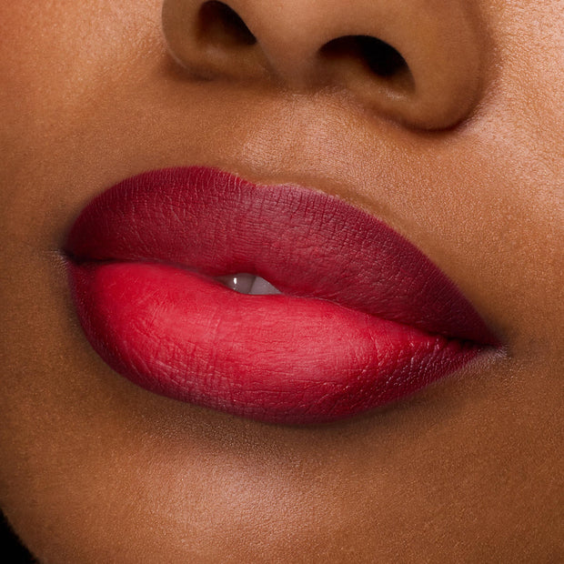 Lips wearing ColourPop Power Pout Lipstick in You Can't Trust Vampires, a bold crimson-to-berry ombré, shown in a tight macro close-up to highlight smooth, velvety coverage and rich pigment.