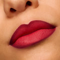 Lips wearing ColourPop Power Pout Lipstick in You Can't Trust Vampires show a deep berry-red gradient with a soft matte, blurred finish in a close-up swatch, highlighting rich pigment and smooth application.