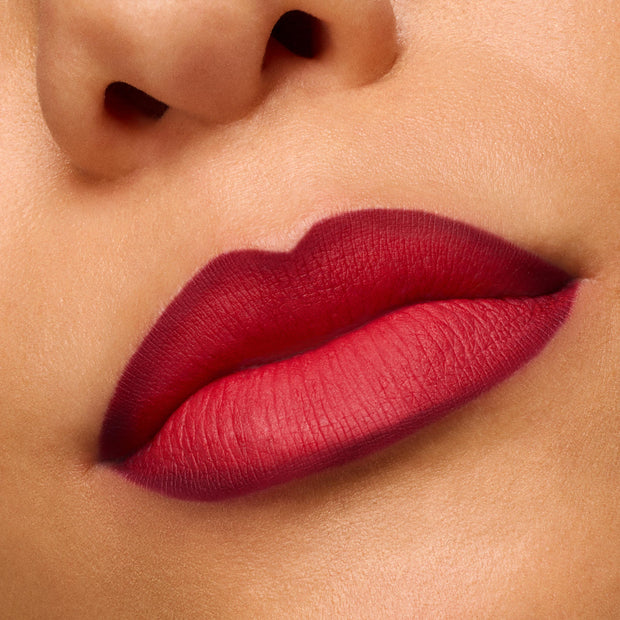 Lips wearing ColourPop Power Pout Lipstick in You Can't Trust Vampires show a deep berry-red gradient with a soft matte, blurred finish in a close-up swatch, highlighting rich pigment and smooth application.