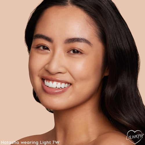 ColourPop Pretty Fresh Tinted Moisturizer in Light 7 W shown on a smiling model, delivering natural, dewy light coverage; close-up face with minimal makeup against a soft beige background.