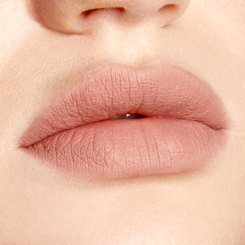 Lips lined and filled with ColourPop Lippie Pencil in Cool BFF, a cool‑toned nude pink shade, showing crisp edges and a soft matte finish in a studio close‑up beauty swatch.