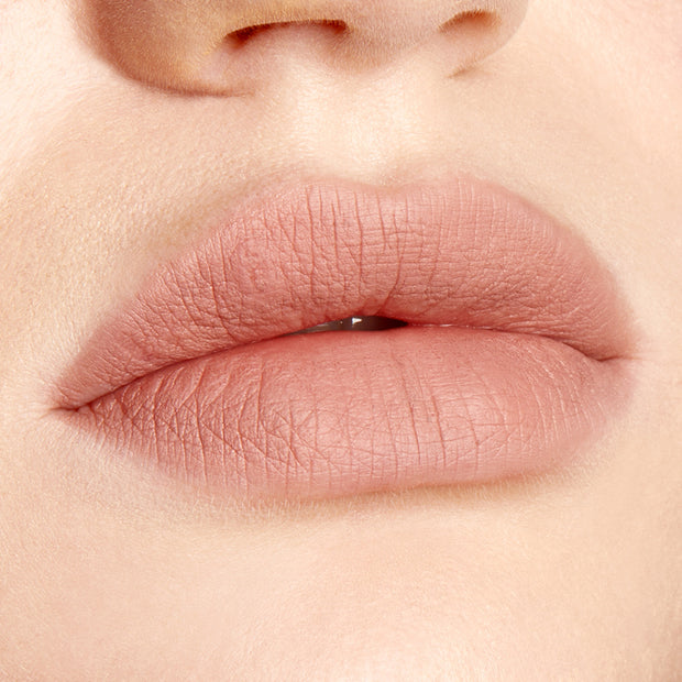 Lips lined and filled with ColourPop Lippie Pencil in Cool BFF, a cool‑toned nude pink shade, showing crisp edges and a soft matte finish in a studio close‑up beauty swatch.