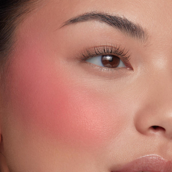 Culver City ColourPop Liquid Blush creating a soft coral-pink flush, diffused across the upper cheekbone on a close-up face, with natural lashes and a hydrated, dewy finish that highlights smooth blendability and payoff.