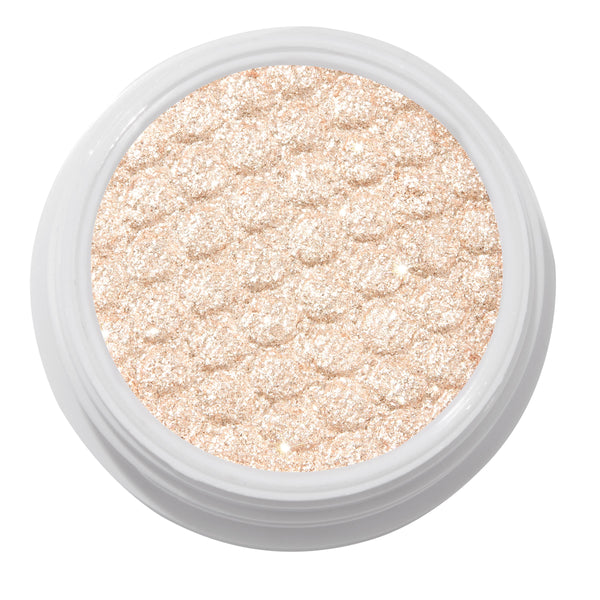 ColourPop Ladybird Super Shock Shadow glistening in a close-up, champagne beige ultra-glitter formula pressed with a scalloped cushion texture and packed in a round white pot, catching light for a high-shine metallic finish on a clean studio background.