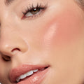 Larchmont Village Lip and Cheek Balm delivering a dewy peachy-pink flush on the cheek and a soft glossy nude tint on the lips, shown in a close-up beauty shot under natural light - ColourPop Lip and Cheek Balm with a skinlike glow.