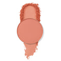 ColourPop Lay Low pressed powder shadow pan sits atop a wide coral-peach matte swatch with softly crushed edges, showcasing the pigment and fine texture against a clean white background.