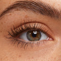 Lashes coated in ColourPop Brown Lengthening Mascara, fanned and defined on a close-up hazel eye, showcasing separated length, natural curl, and soft brown pigment against clean lids and a groomed brow.