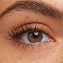 Lashes coated in ColourPop Brown Lengthening Mascara, fanned and defined on a close-up hazel eye, showcasing separated length, natural curl, and soft brown pigment against clean lids and a groomed brow.