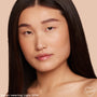 Model wearing ColourPop Pretty Fresh Creamy Concealer in Light 50 W (warm), showing smooth, natural coverage on under-eyes and cheeks; close-up against a beige backdrop highlights a hydrated, skin-like finish.
