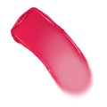 Girls Night shade swatch of ColourPop Lip and Cheek Balm sweeps in a curved stroke, revealing vibrant fuchsia-pink with a creamy, glossy finish that fades to a soft pink edge on a clean white background.