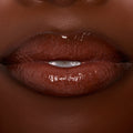 Glossy lips wearing ColourPop Ultra Glossy Lip in Coffee Break, a rich coffee‑brown creme shade, reflecting high shine in a tight close-up studio shot.
