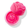 Enchanted Rose ColourPop Lip Mask sits open, revealing a glossy hot pink balm with a rose-swirled texture, while a matching fuchsia rose-shaped cap rests askew on the clear round jar against a bright white background.