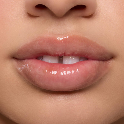 Shiny, moisturized lips wearing the Orange Vanilla Lip Mask in a tight studio close-up, highlighting high gloss and smooth texture as part of the ColourPop Lip Care Kit.
