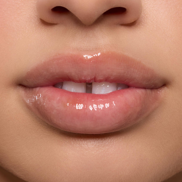 Shiny, moisturized lips wearing the Orange Vanilla Lip Mask in a tight studio close-up, highlighting high gloss and smooth texture as part of the ColourPop Lip Care Kit.