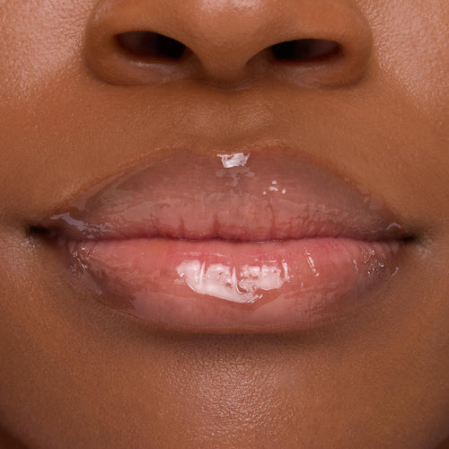 Lips wearing ColourPop Lip Mask in Strawberry Milk, gleaming with a sheer pink, high-shine finish in a tight close-up that emphasizes smooth, hydrated texture.