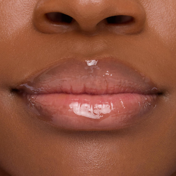 Lips wearing ColourPop Lip Mask in Strawberry Milk, gleaming with a sheer pink, high-shine finish in a tight close-up that emphasizes smooth, hydrated texture.