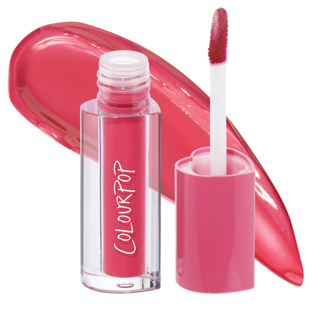 ColourPop Lip Stain in Juice Box, a vibrant raspberry-pink tint, shown with cap off as the white doe-foot applicator rests beside the clear tube with pink cap, a glossy swatch swept behind to show payoff on a white studio background.