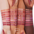 Caramella Lippie Stix swatch glides across three forearms, shown among labeled shades from the ColourPop Lippie Stix collection; rosy‑nude pigment and creamy finish displayed with Lippie Stix pens in frame for a multi‑skin‑tone comparison.