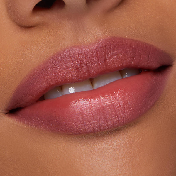 ColourPop Lippie Pencil in Me Again lining and filling lips, creating a precise rosy‑mauve satin finish; close-up of a model’s slightly parted mouth shows smooth texture and clean edges for an everyday nude lip look.