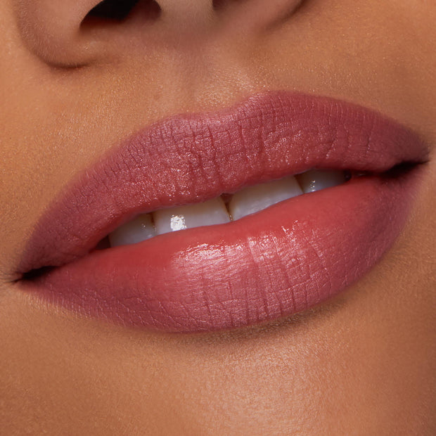 ColourPop Lippie Pencil in Me Again lining and filling lips, creating a precise rosy‑mauve satin finish; close-up of a model’s slightly parted mouth shows smooth texture and clean edges for an everyday nude lip look.