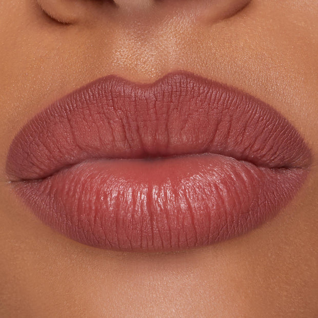 Full lips lined and filled with ColourPop Lippie Pencil in Double Tap, showing a smooth, rosy-mauve hue with defined edges and a soft satin finish in a studio close-up, highlighting precise application for everyday wear.