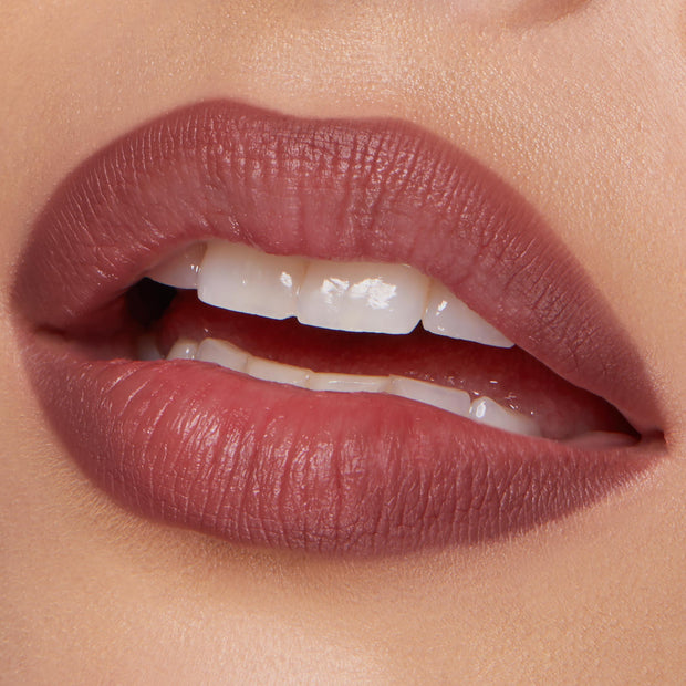 ColourPop Lippie Pencil Double Tap lining softly parted lips, delivering a matte rosy-mauve outline and fill with precise edges; close-up beauty shot on natural skin in studio lighting.