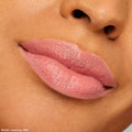 Lips wear ColourPop Lippie Stix shade NBD, a soft pink‑nude with a creamy satin finish, showing smooth, even color payoff; product from The Lil Box of Lippie Stix, beauty swatch on medium‑tan skin in studio lighting.
