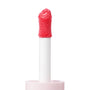 Doe-foot applicator coated in Angel Face ColourPop Liquid Blush, a vibrant pink shade, shown in a macro close-up on a white background, highlighting the plush wand texture, white stem, and pale pink cap.