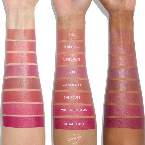 ColourPop Wildest Dreams Liquid Blush swatch on three arms in varied skin tones, a rich rosy‑pink stripe between She’s Cute and Royal Flush, shown with other labeled shades (THX, Super Shy, Angel Face, IKTR, Culver City) to display dewy pigment.