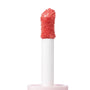 Doe-foot applicator coated in Super Shy, a peachy coral ColourPop Liquid Blush, showcasing plush bristles and creamy, glossy texture on a white wand in a close-up studio shot against a clean white background.