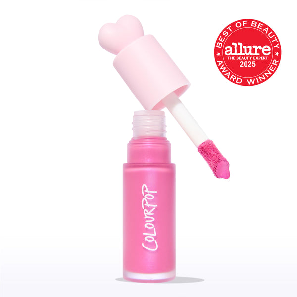 ColourPop Liquid Blush Sweet Treat shown open, doe-foot applicator lifting vivid pink pigment from a frosted pink bottle with a heart-shaped cap and ColourPop logo, on a white background beside an Allure Best of Beauty 2025 award badge.