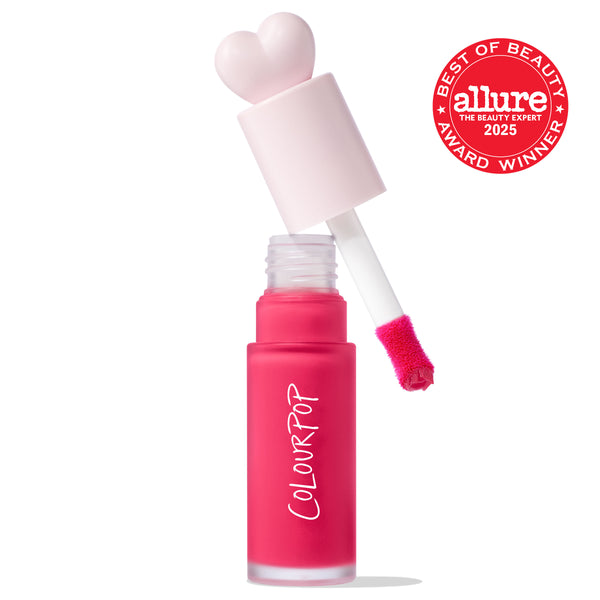 ColourPop Liquid Blush in Wildest Dreams, cap off - heart-shaped pale pink cap and doe-foot applicator hovering over a frosted hot pink bottle, with an Allure Best of Beauty 2025 award badge on the right against a white background.