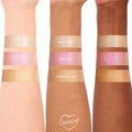 Pink Pony ColourPop Liquid Highlighter swatched on three arms, showing a luminous pink pearl sheen between shades Sugar Donut and Immediately, Yes; reflective shimmer across light, medium, and deep skin tones for easy shade comparison.