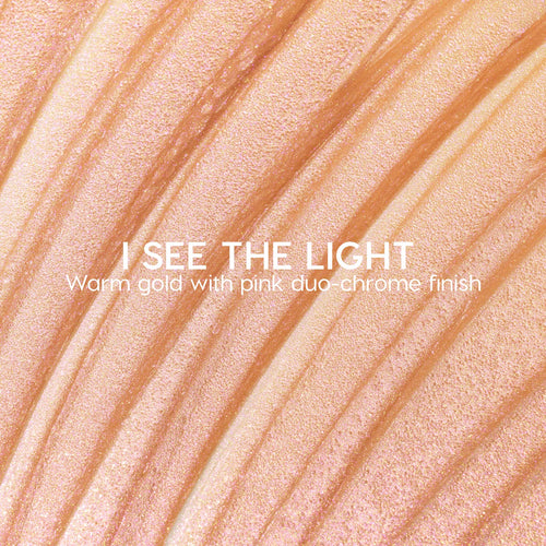 I See the Light ColourPop Liquid Highlighter swatched in sweeping ridges, showing a warm gold base with pink duochrome shimmer; creamy liquid texture gleams under light in a close-up macro for a luminous glow.