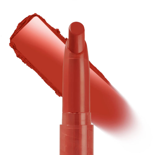 Love Life ColourPop Lippie Stix gliding a rich warm red swatch, the slim twist-up lipstick crayon shown in macro with a smooth pigment streak behind on a clean white background.