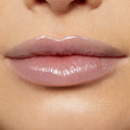 Glossy lips wearing Team Edward Lux Lip Oil reflect a high-shine, sheer pink finish, captured in a studio close-up to showcase the smooth, hydrated look of ColourPop Lux Lip Oil on natural lips.