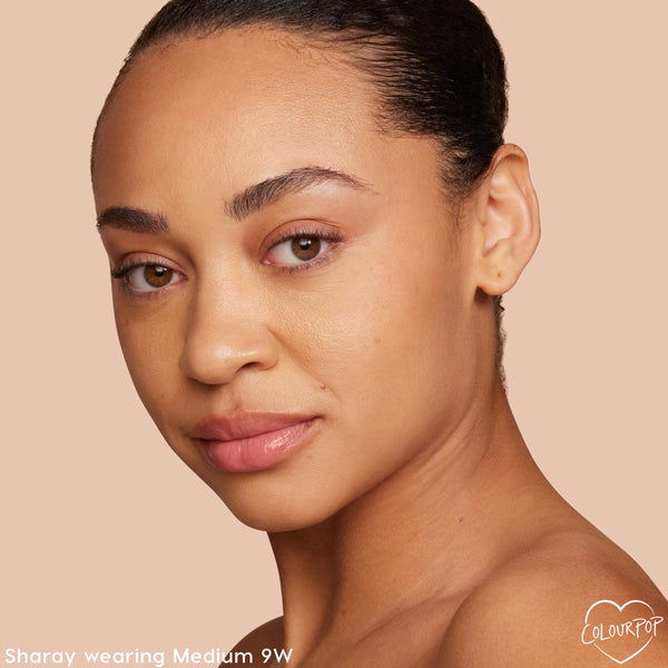 Model showcasing ColourPop Pretty Fresh Tinted Moisturizer, shade Medium 9W, wearing a natural, dewy finish with even coverage; close-up three-quarter face against a nude background, highlighting warm undertone and skin-like glow.