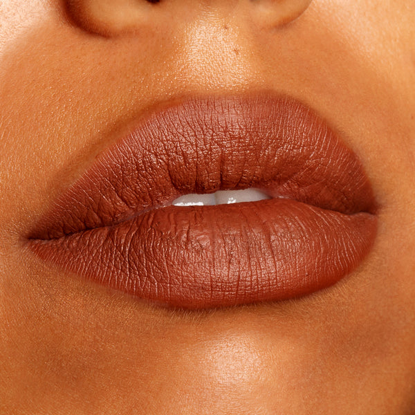 Full lips lined and filled with ColourPop Lippie Pencil BFF3, a warm cinnamon-brown matte lip liner, shown in a close-up swatch on medium‑deep skin with crisp edges and smooth coverage.