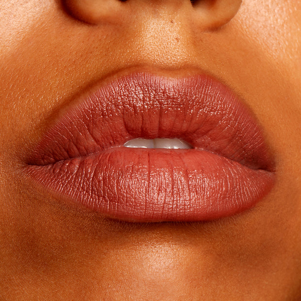 Lips wearing BFF2 ColourPop Lippie Pencil, lining and filling in a warm rosy-brown nude with a creamy satin finish; close-up beauty swatch showing precise lip definition and smooth texture.
