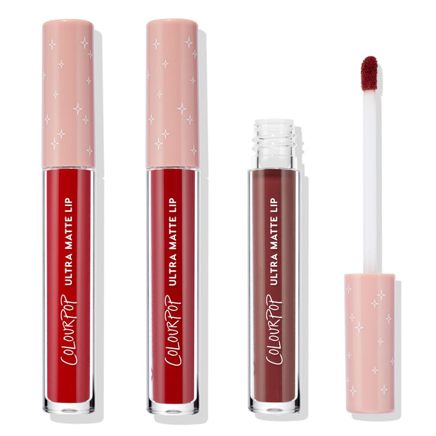 ColourPop Ultra Matte Lip Major Hottie set stands upright, two closed tubes and one open showing a doe‑foot applicator coated in deep red, blush‑pink star‑print caps, studio product shot on a white background.